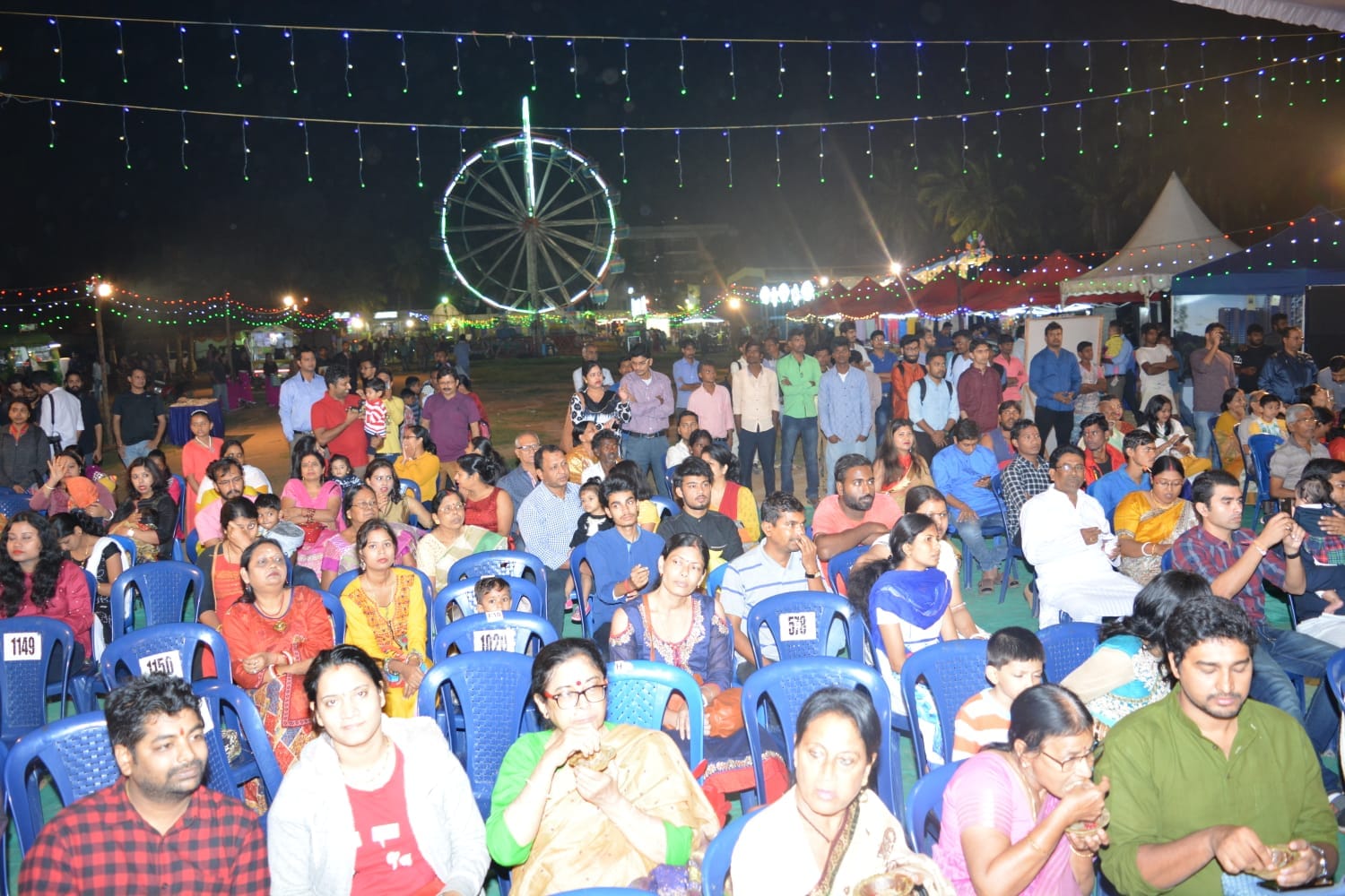 Packed crowd at VBA Durga Puja under festive lights